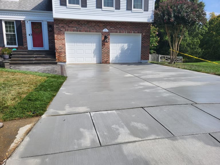 After — the driveway and widened apron with the red front door beyond