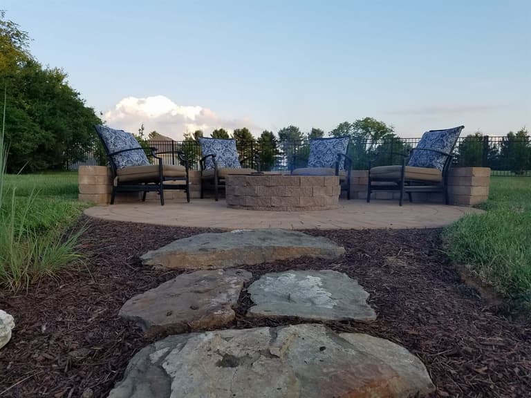 Fire pit on a circular paver patio with seating