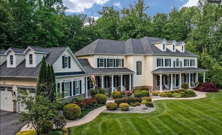 Finished front landscape of a colonial home, with shaped beds, walkway and foundation plantings as one design